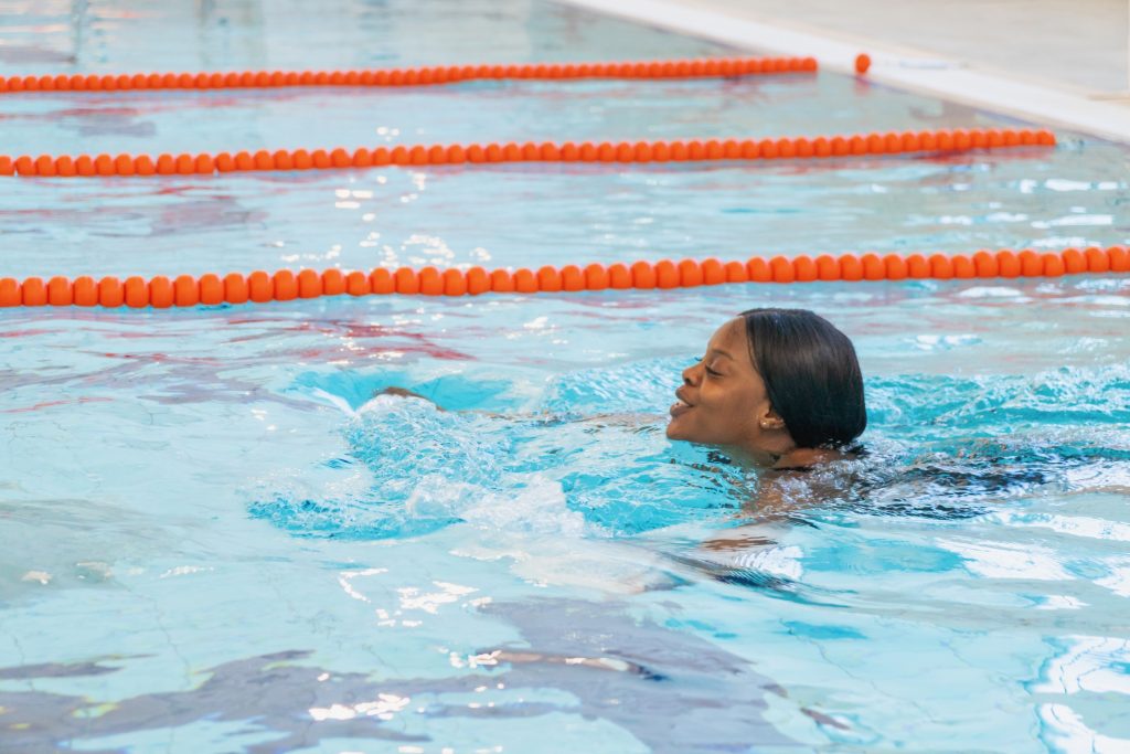 smiling woman swimming in pool