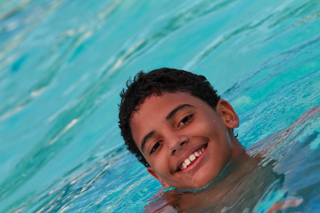 smiling boy swimming