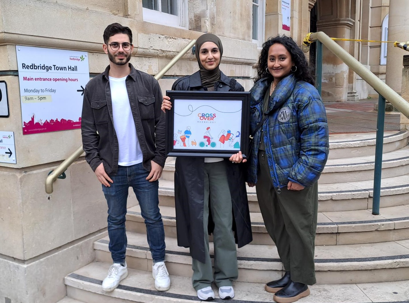 Three people standing outside Town Hall. Redbridge Design Challenge - Winner